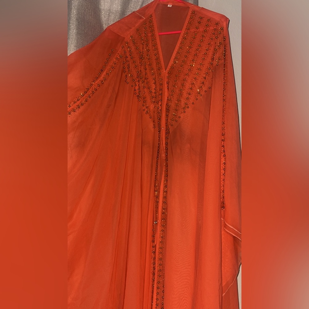 bright salmon colored abaya with crystal design an fairy like sleeves